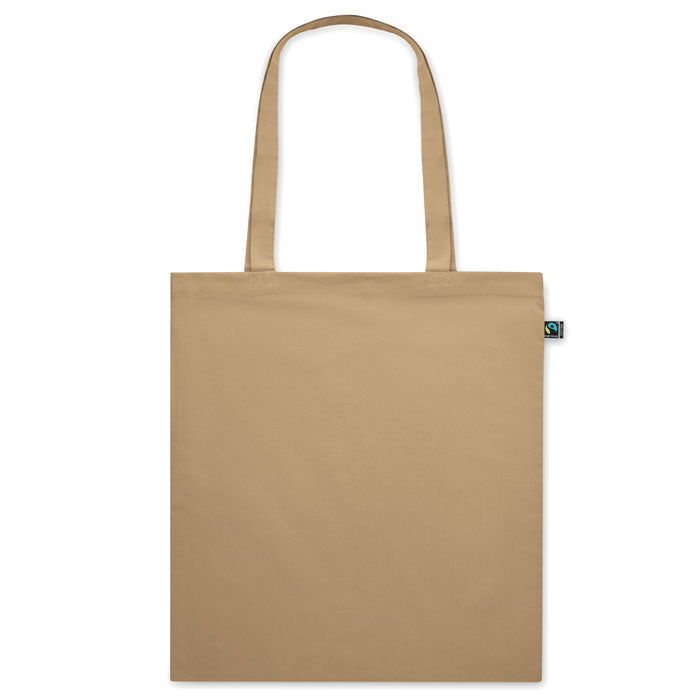 Bolsa de tela beige OSOLE COLOUR con asas largas y etiqueta de comercio justo. Ideal para ferias, tiendas y campañas ecológicas.