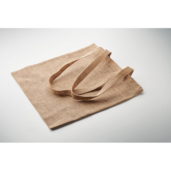 ZOLANG - Bolsa de yute de asas largas ecológica extendida sobre superficie blanca, ideal para personalización y uso promocional.