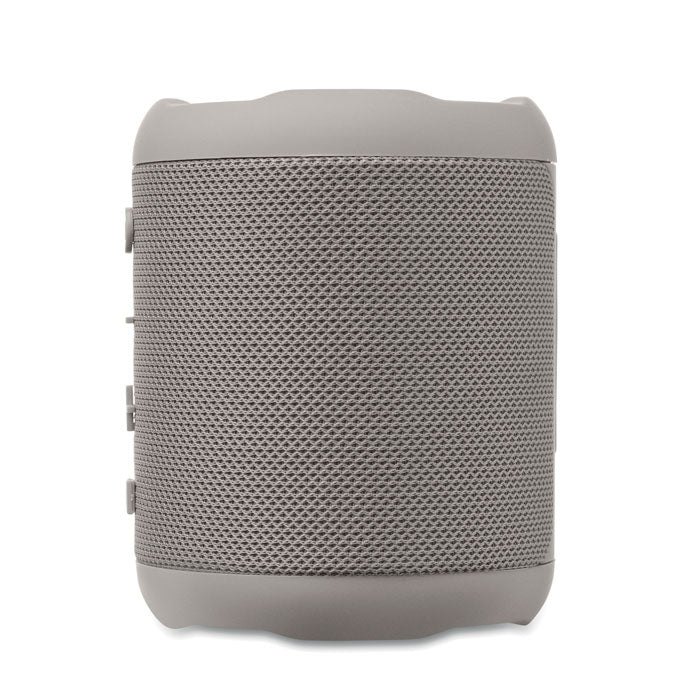 Vista frontal de un altavoz inalámbrico ABS de 5 W en color gris, con malla de protección y botones de control.