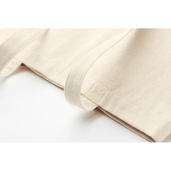Detalle de costura y asas reforzadas de la bolsa RASSA de canvas con fuelle. Alta calidad y durabilidad para uso intensivo en compras o ferias.
