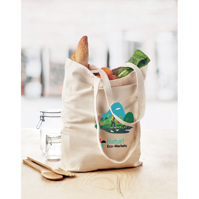 Bolsa RASSA personalizada con logo Natur! Eco-Markets, ideal para ferias y campañas sostenibles. Canvas resistente de 270 gr/m² con fuelle amplio.