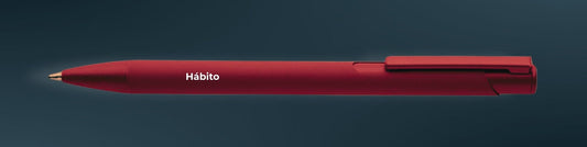 Boligrafo rojo con Habíto en blaco. Fondo azul marino