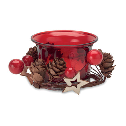 Vela decorativa en vaso de cristal con adornos festivos