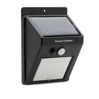 Foco con 20 luces LED y sensor de movimiento sobre pared gris