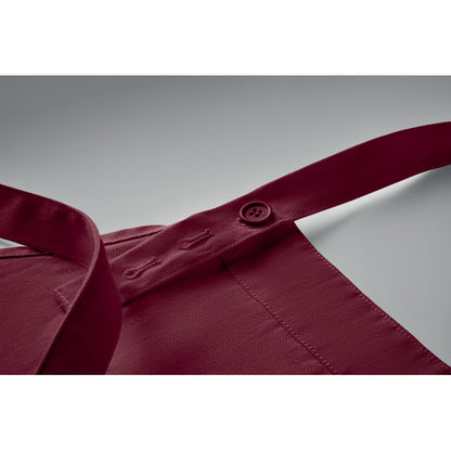 Detalle de cinta ajustable de delantal con botones