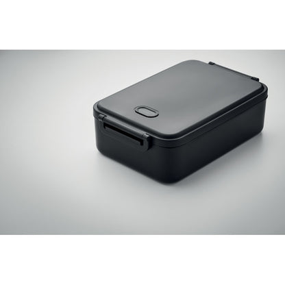 Taper negro rectangular cerrado sobre un fondo gris neutro