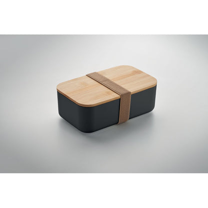 Detalle de la tapa de bambú encajada sobre la fiambrera negra