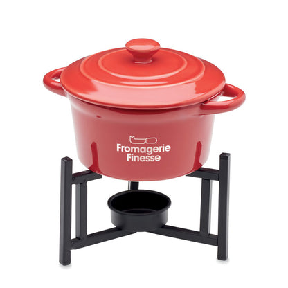 Recipiente de cerámica para fondue sobre base con espacio para vela.
