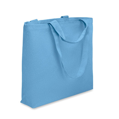 Bolsa de playa de lona azul con asas cortas y asas largas con fuelle
