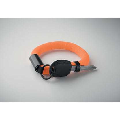 Vista superior de Llavero pulsera flotante naranja sobre fondo gris