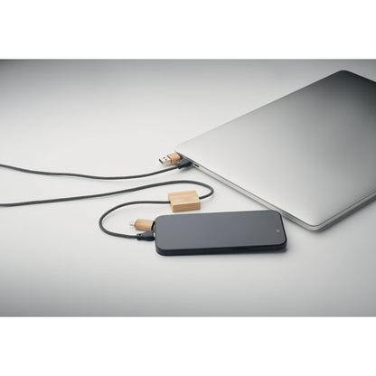 Portátil con móvil cargando con cable adaptador de madera