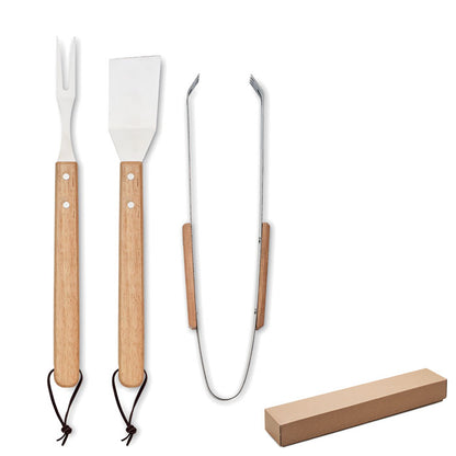 Set de espátula, tenedor y pinza con mango de madera para barbacoa en caja kraft con tapa.