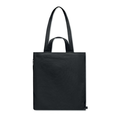 Vista trasera de totebag para playa o compras negra con fuelle y asas largas y cortas y con bolsillo lateral con cremallera color negro