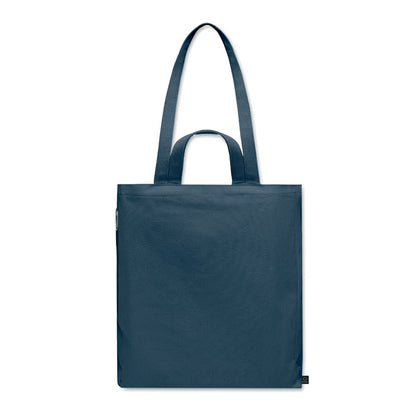 Vista trasera de totebag para playa o compras negra con fuelle y asas largas y cortas y con bolsillo lateral con cremallera color azul marino