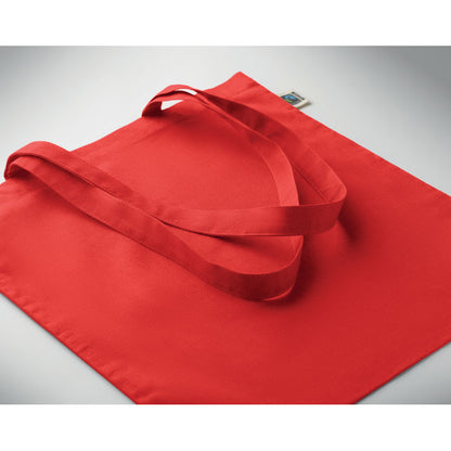 Bolsa roja de algodón extendida sobre mesa
