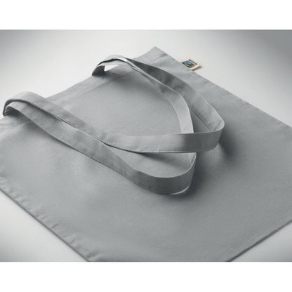 Bolsa Fairtrade gris colocada sobre superficie