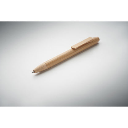Bolígrafo de madera sobre superficie gris 