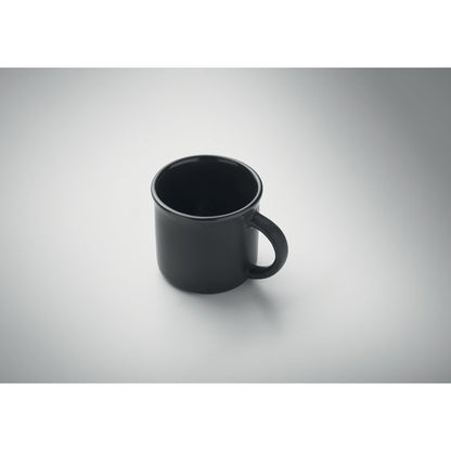 Vista superior de taza de espresso negra con fondo gris