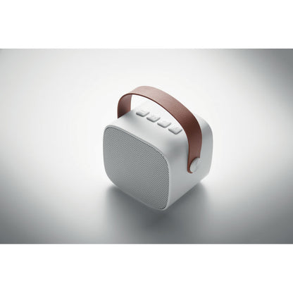Altavoz inalámbrico blanco de forma cuadrada con asa marrón