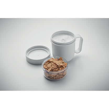 Vista superior de taza blanca con tapa y contenedor de alimentos