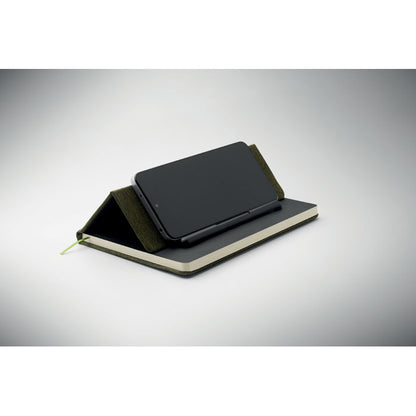 M´vil colocado en horizontal sobre soporte de libreta