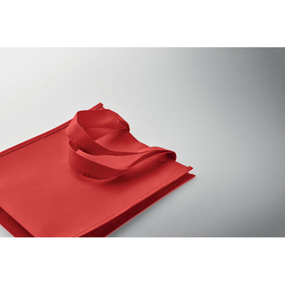 Bolsa tumbada de RPET roja sobre fondo gris