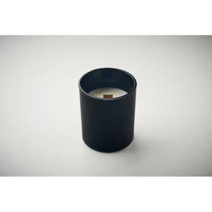 Vista superior de vela de vidrio color ambar con mecha de madera