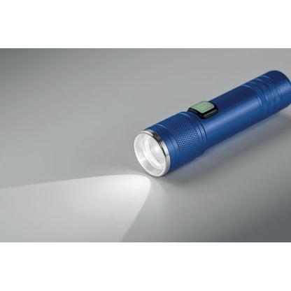 Linterna azul de luz COB encendida sobre una superficie gris