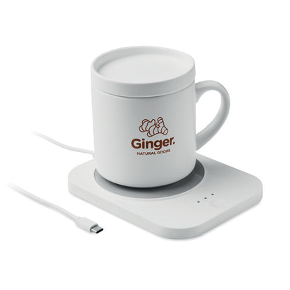 Taza blanca personalizada con logotipo sobre calentador inalámbrico