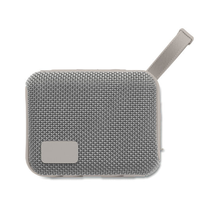 Vista superior del altavoz inalámbrico de 5 W con textura de tejido gris y asa de sujeción.