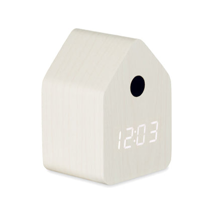 Vista lateral de reloj despertador cuco blanco forma de casa