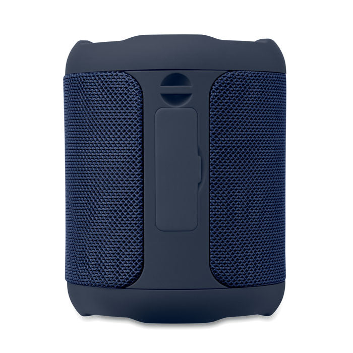 Vista frontal de un altavoz inalámbrico ABS azul, con detalles en tejido y botón de control visible.