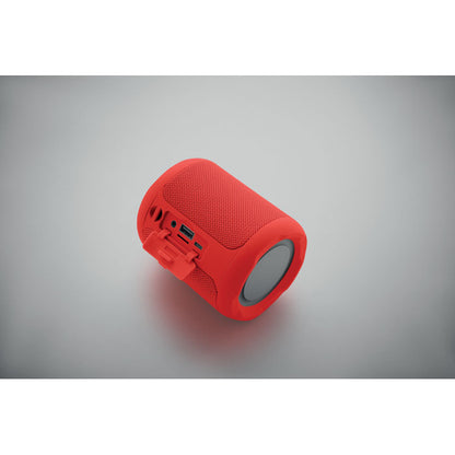 Vista lateral de altavoz inalámbrico rojo con botones en relieve