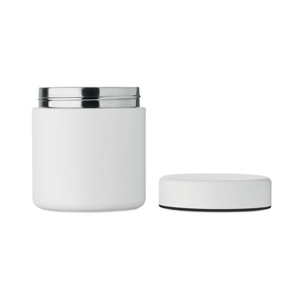 Tarro termo blanco junto a portátil en entorno de trabajo