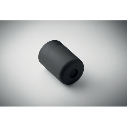 Vaso negro tumbado sobre fondo claro