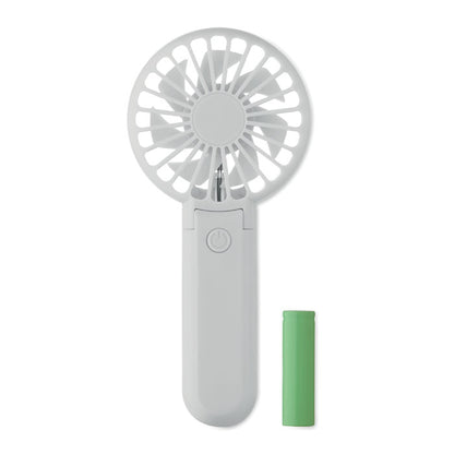Ventilador rosa plegado apoyado sobre superficie