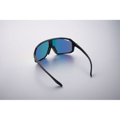 Gafas con lente azul apoyadas sobre fondo claro