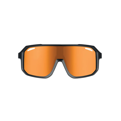 Gafas con lente naranja apoyadas en superficie
