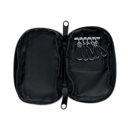 Funda para llaves abierta mostrando interior con arandelas