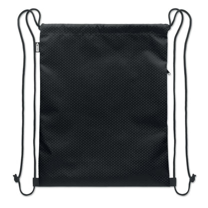 Mochila negra apoyada sobre superficie clara