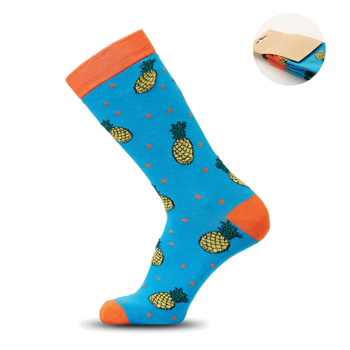 FUNNY L - Calcetines estampados alegres con diseño de piña sobre fondo azul y detalles naranjas.