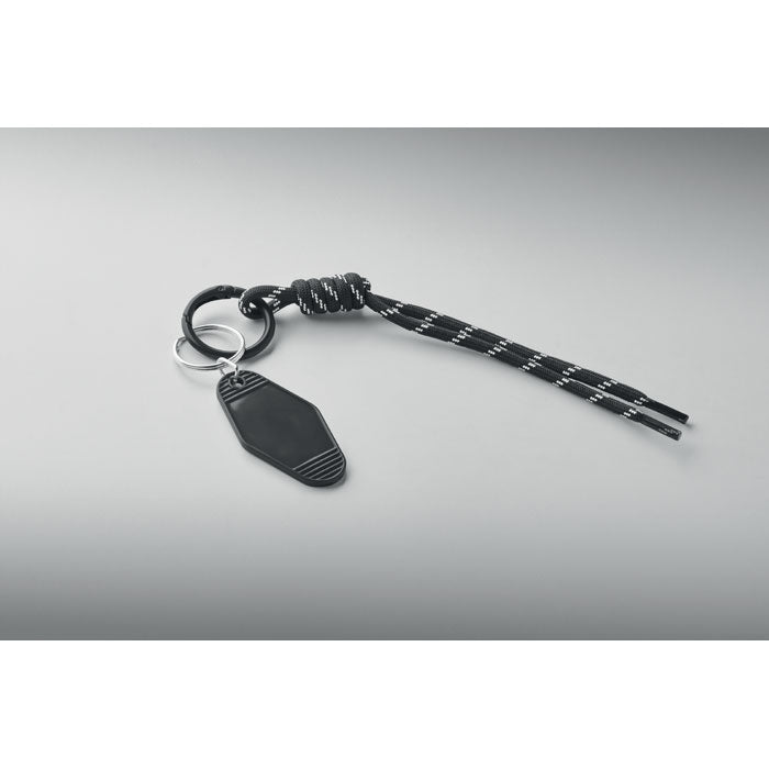 KEYBRAID - Llavero cuerda trenzada con nudo, anilla de aleación y etiqueta ABS sobre fondo gris.