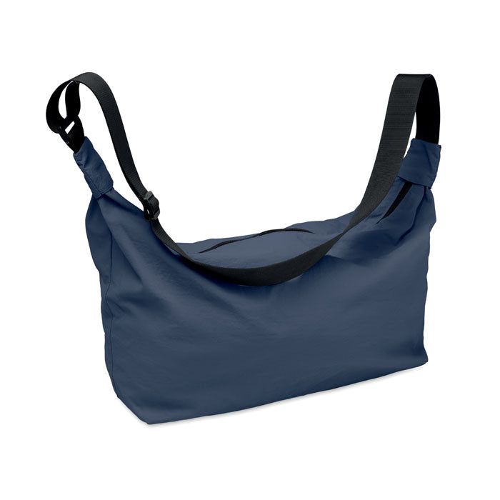 SLING - Bolsa urbana cruzada de nailon en color azul con correa ajustable y diseño moderno.