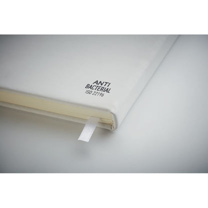 Detalle sello anti bacterias en libreta blanca