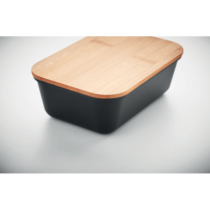 Vista superior de fiambrera negra de plástico con tapa de madera