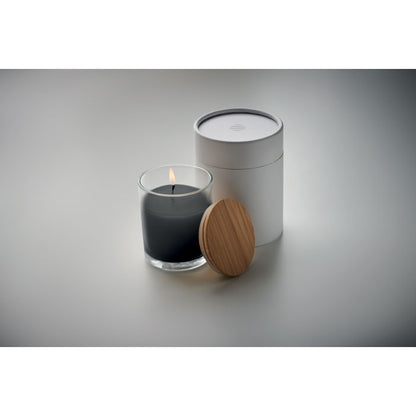 Vela negra encendida de cristal con tapa de madera y caja blanca