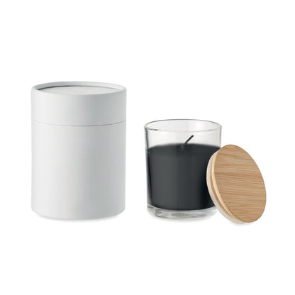 Vela negra de vidrio con tapa de madera y caja cilíndrica al lado