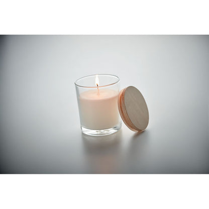 Vela de vainilla de cristal con tapa de madera con fondo gris