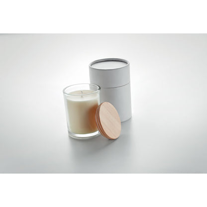 Vela de cristal blanca con tapa de madera en fondo gris