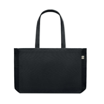 Bolsa de algodón negra con asas largas y fuelle y con etiqueta de algodón orgánico cosida en un lateral
